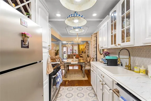 a kitchen with cabinets and chandelier