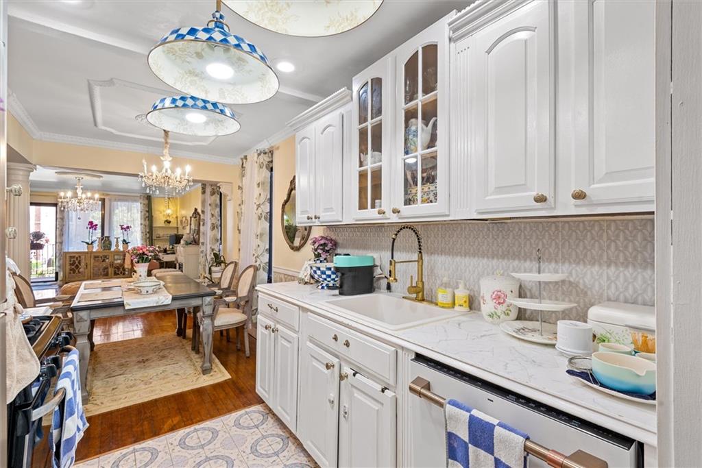 7401 Shore Road, Unit 1E Brooklyn, NY 11209 - Photo 15 of 21 a kitchen with cabinets and chandelier