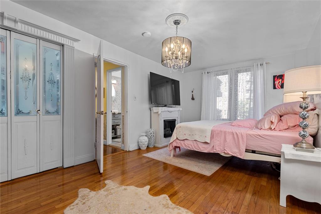 7401 Shore Road, Unit 1E Brooklyn, NY 11209 - Photo 19 of 21 a spacious bedroom with a bed and wooden floor