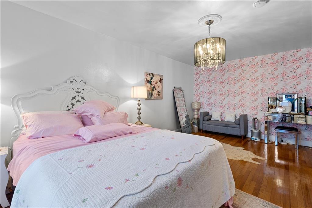 7401 Shore Road, Unit 1E Brooklyn, NY 11209 - Photo 20 of 21 a bedroom with a bed and wooden floor