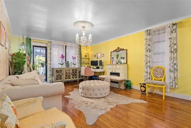 a living room with furniture chandelier and a chandelier