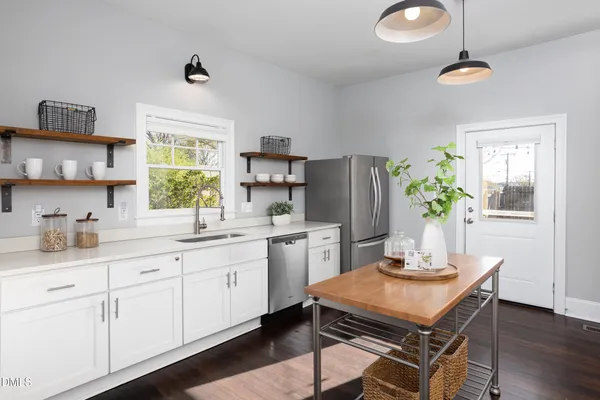 a kitchen with refrigerator and window