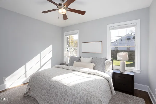 a bedroom with a bed lamps and window