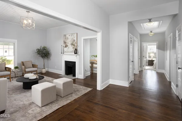 a living room with fireplace furniture and a wooden floor