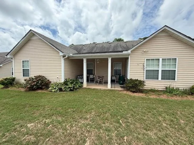 a view of a house with backyard and porch