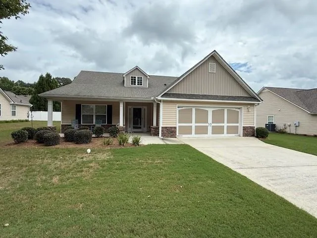 a front view of a house with a yard