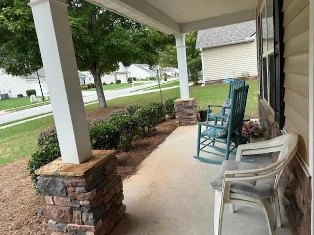 a view of a patio with table and chairs potted plants with wooden floor