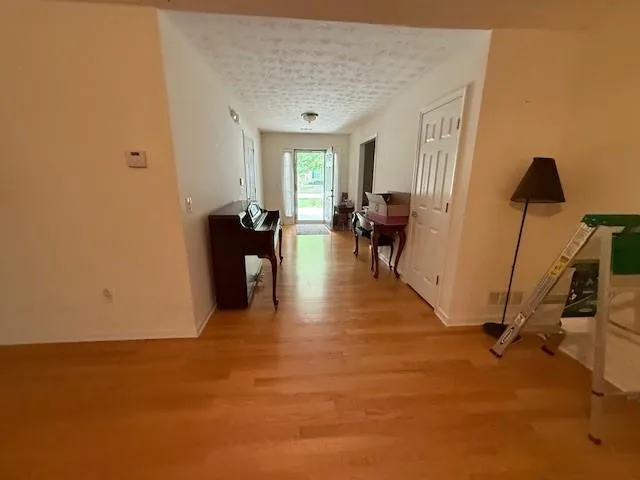 a view of a livingroom with furniture and a window