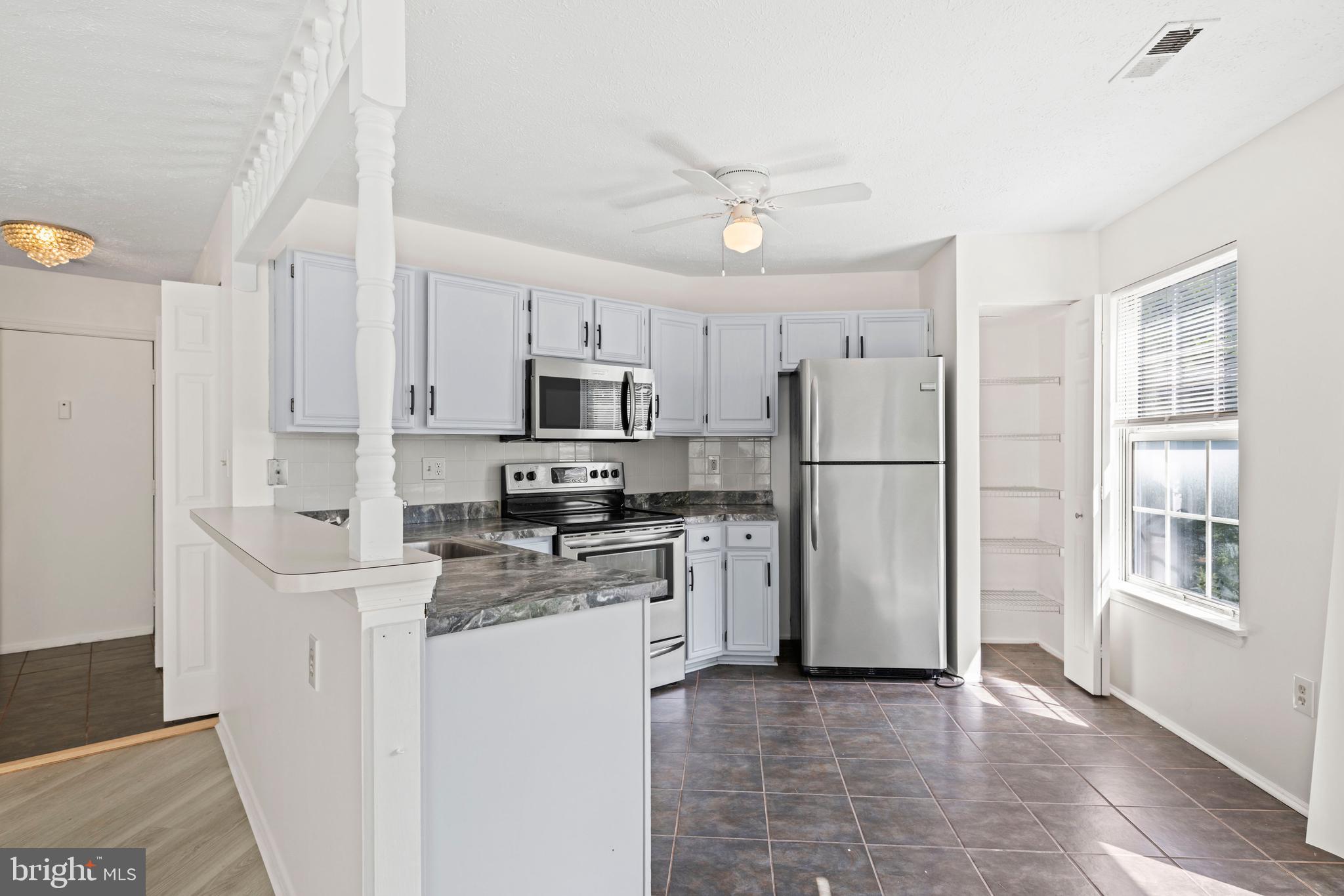 31 Beagle Run, Unit 88 Nottingham, MD 21236 - Photo 19 of 43 a kitchen with stainless steel appliances a refrigerator sink and microwave