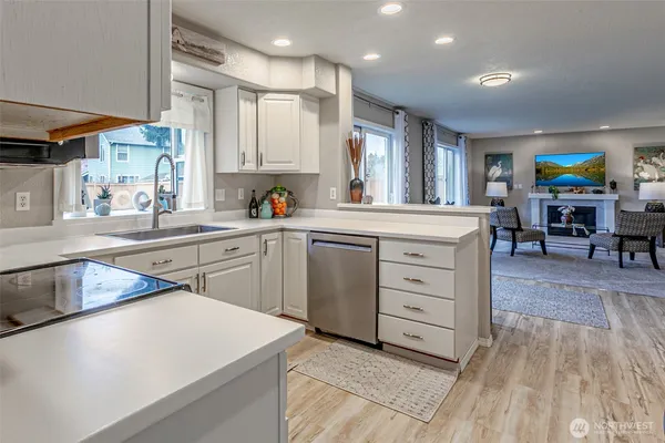 a kitchen with a stove a sink and a refrigerator