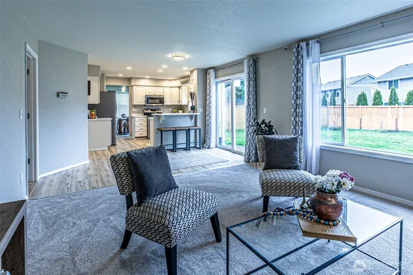 a living room with furniture and a large window