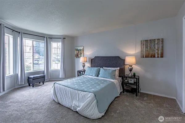 a bedroom with a bed and lamp