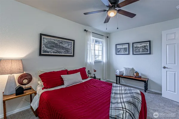 a bedroom with a bed and a chandelier