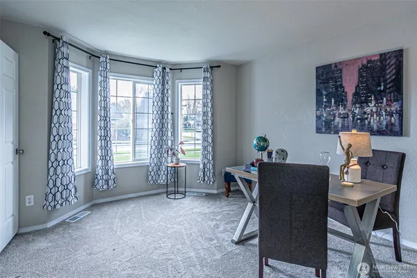 a workspace with furniture and a window