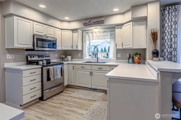 a kitchen with a sink cabinets and window