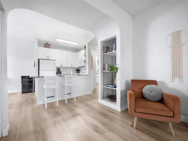 a living room with furniture and a wooden floor