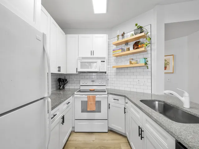 a kitchen with cabinets appliances and a sink