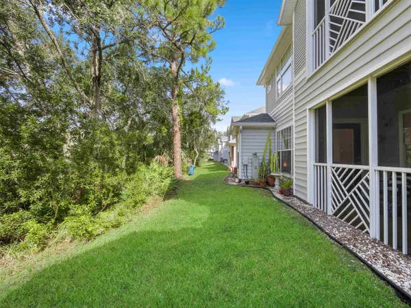 a view of a house with backyard and porch