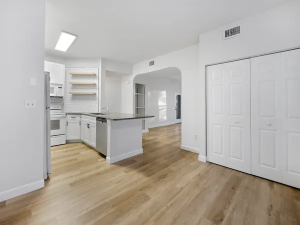 a view of kitchen with wooden floor and electronic appliances