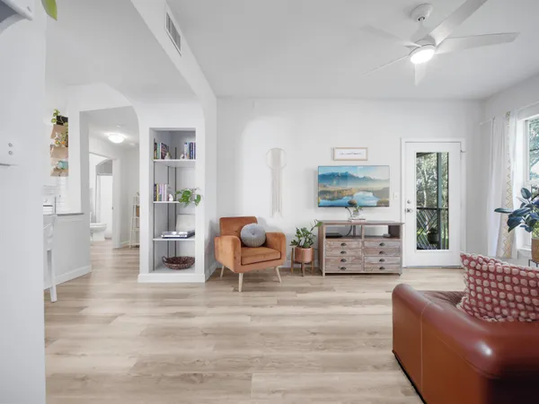 a living room with furniture and wooden floor