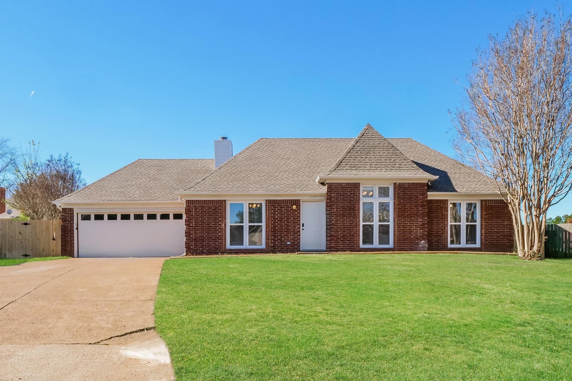 a front view of house with yard and green space