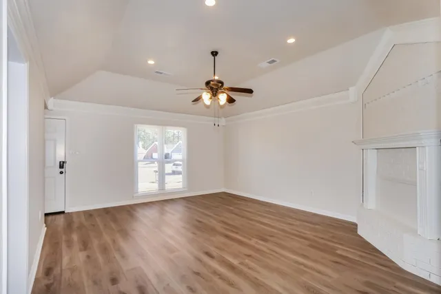 wooden floor in an empty room with a window