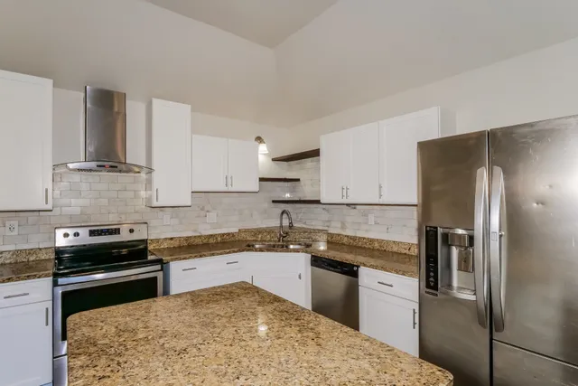 a kitchen with a sink stove and refrigerator