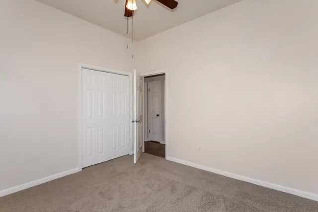 an empty room with a empty space and a ceiling fan