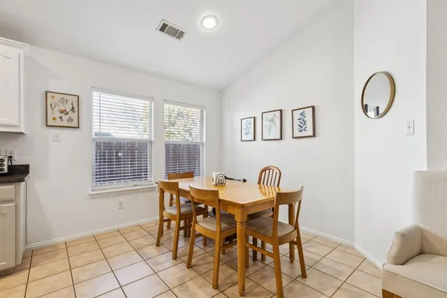 a view of a dining room with furniture and a window