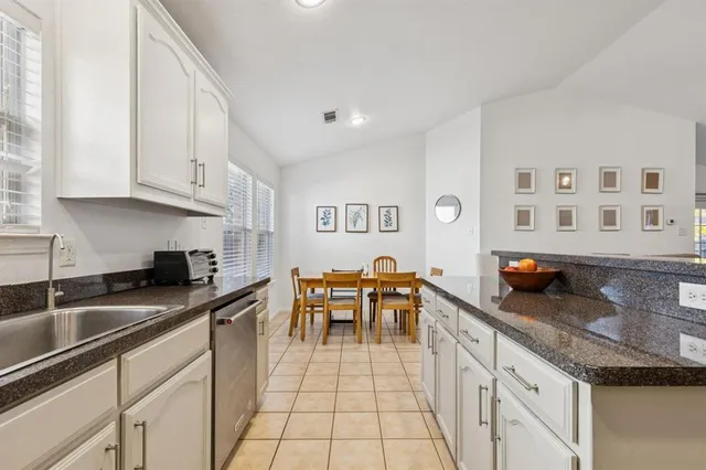a kitchen with stainless steel appliances granite countertop a sink and cabinets