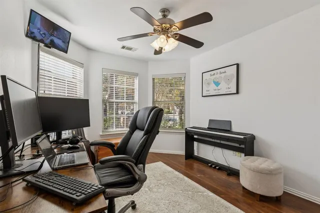 a view of a workspace with furniture and a window