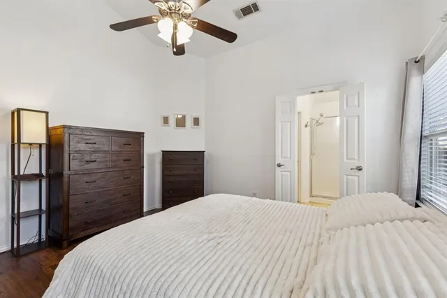 a bedroom with a bed and a dresser