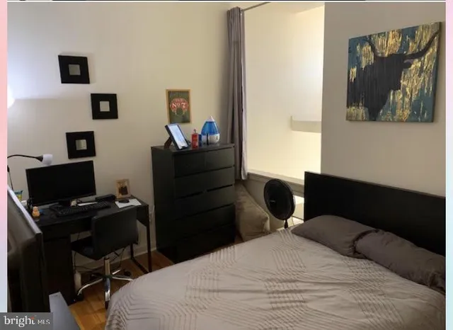 a bedroom with a bed and a desk