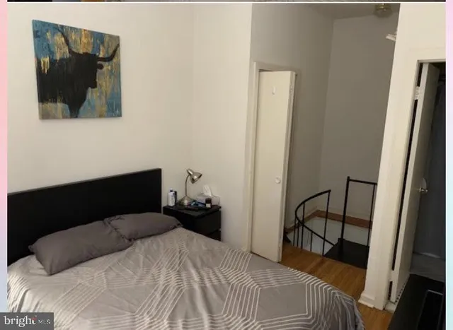 a bedroom with a bed and a mirror