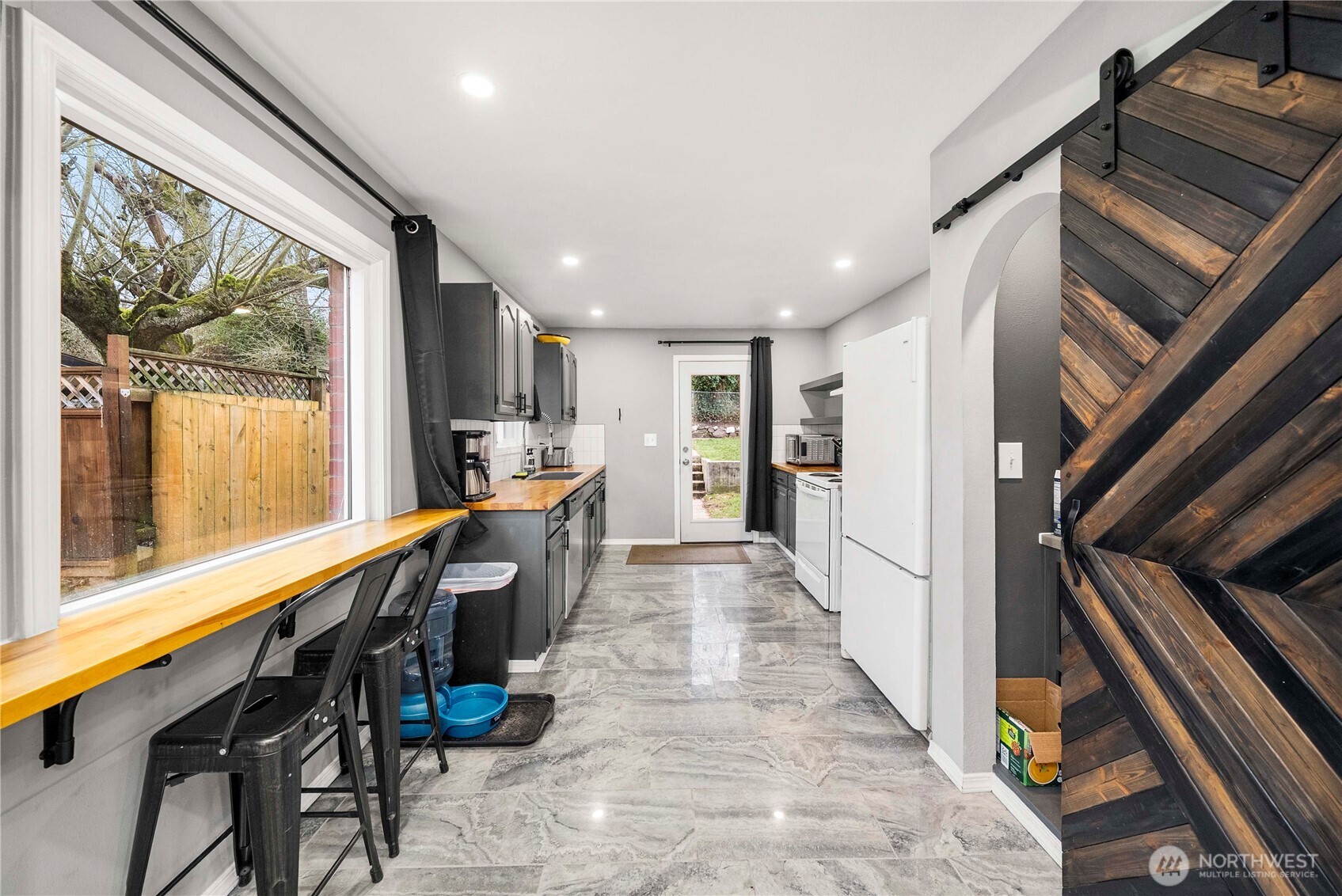 3608 South L Street Tacoma, WA 98418 - Photo 11 of 40 a hallway with wooden furniture and large windows