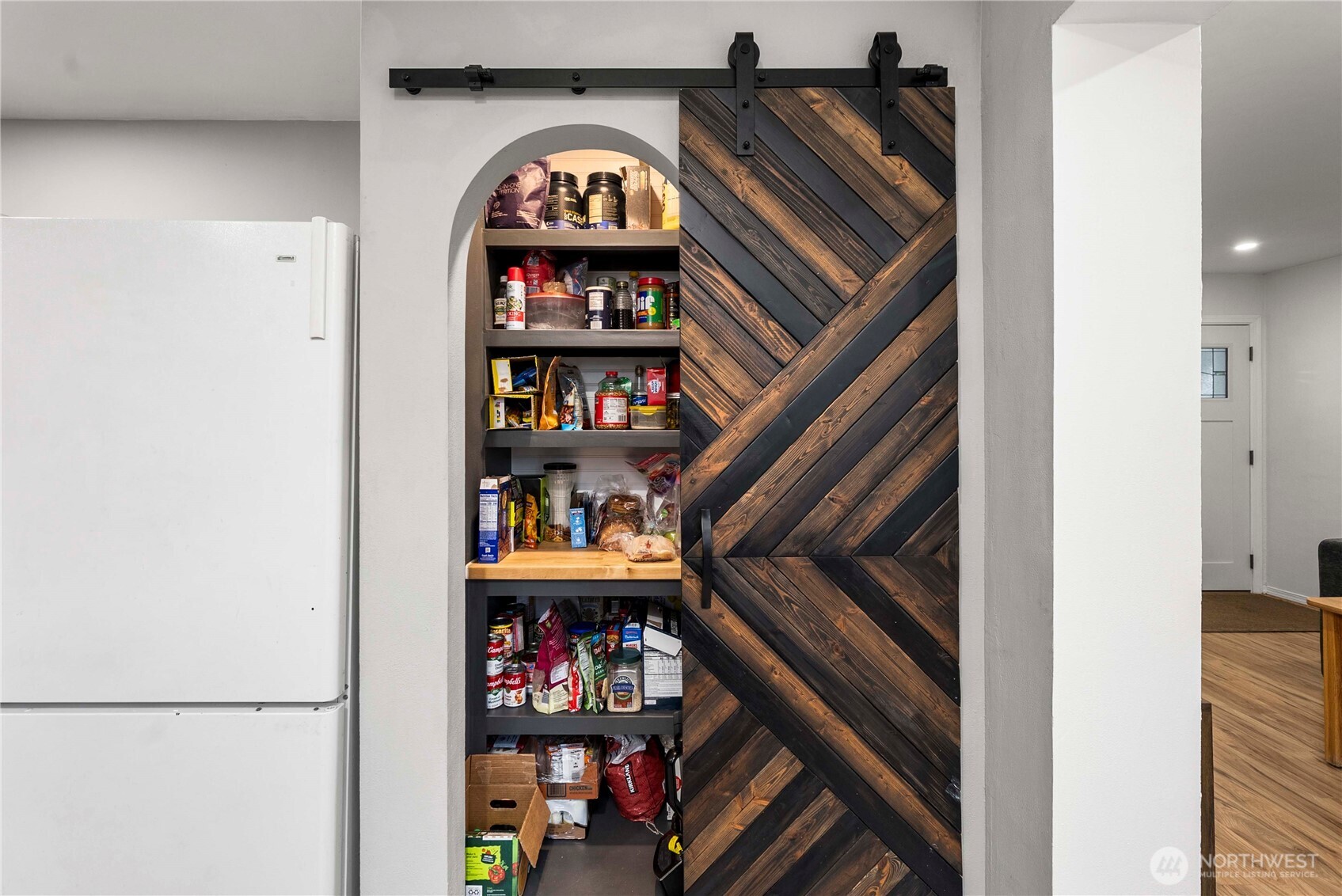 3608 South L Street Tacoma, WA 98418 - Photo 12 of 40 a view of a book shelf with lots of frames on wall