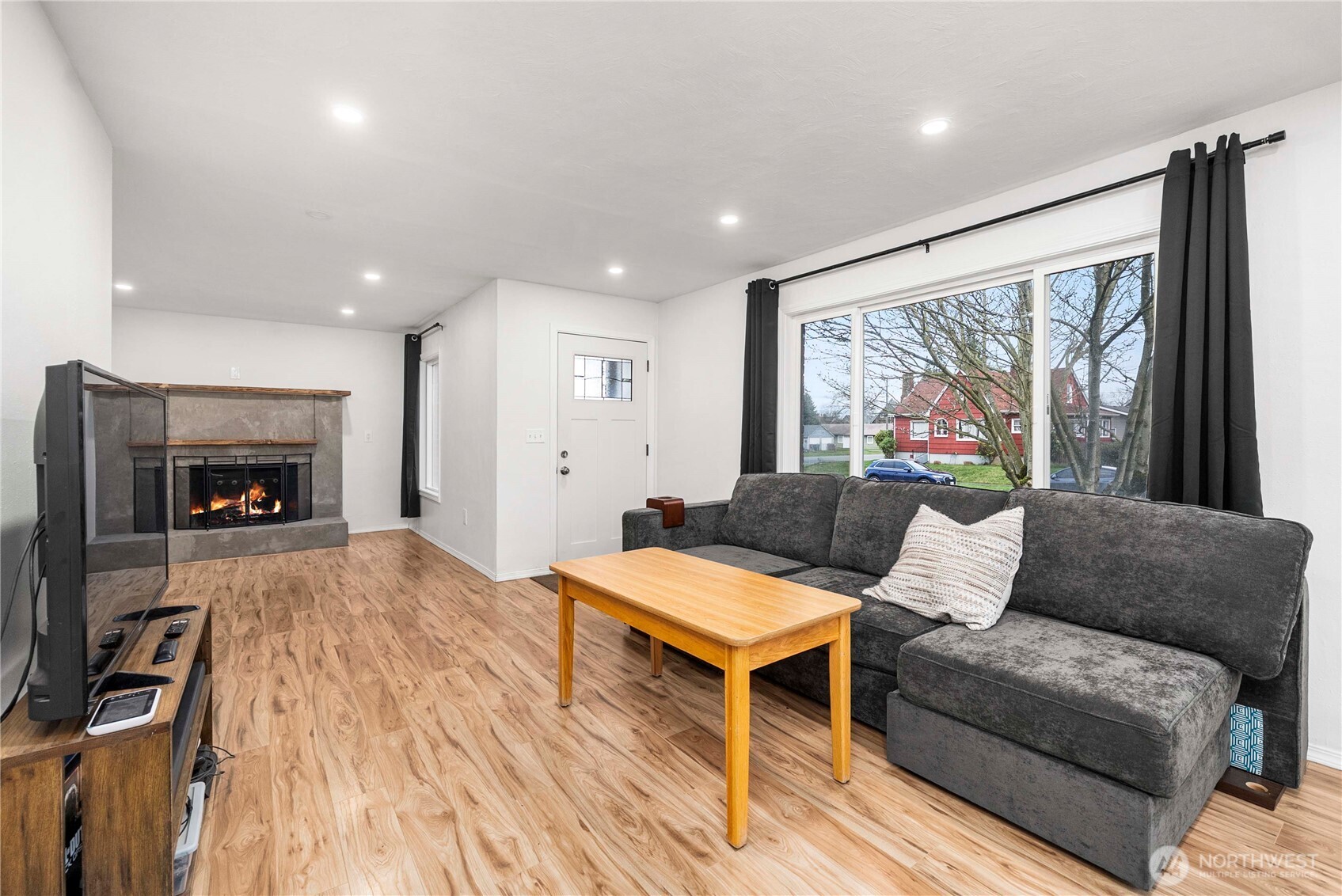 3608 South L Street Tacoma, WA 98418 - Photo 3 of 40 a living room with furniture and a fireplace