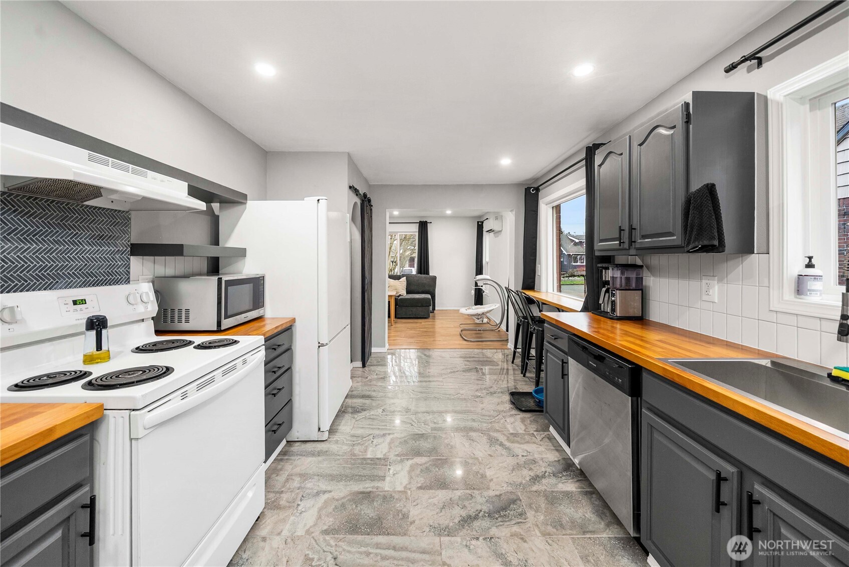 3608 South L Street Tacoma, WA 98418 - Photo 8 of 40 a kitchen with kitchen island wooden cabinets a sink stove and refrigerator