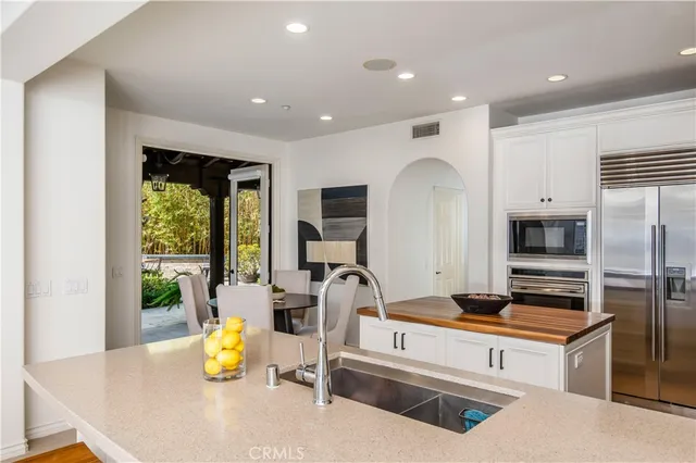 a kitchen with a sink appliances and a counter top space