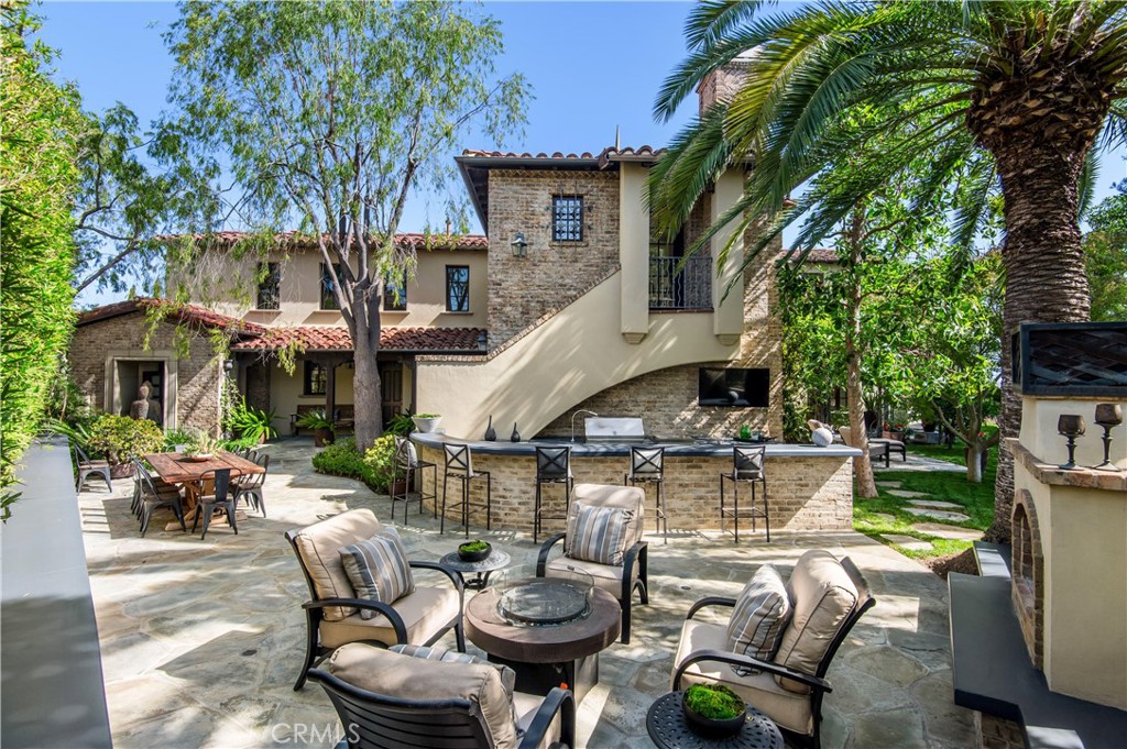 6 Pacific Winds Newport Coast, CA 92657 - Photo 8 of 10 a view of a patio with table and chairs potted plants and a large tree