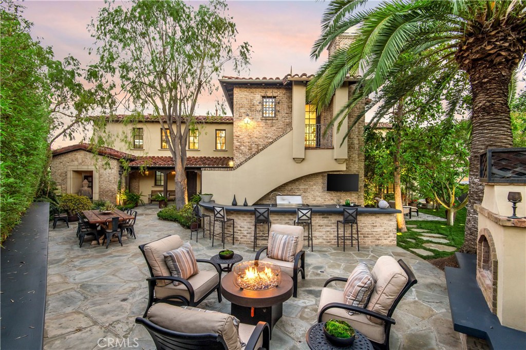6 Pacific Winds Newport Coast, CA 92657 - Photo 10 of 10 a view of a patio with table and chairs with a fire pit and a barbeque grill