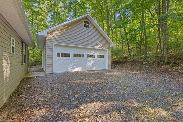a view of a lush green field with mountains in the background