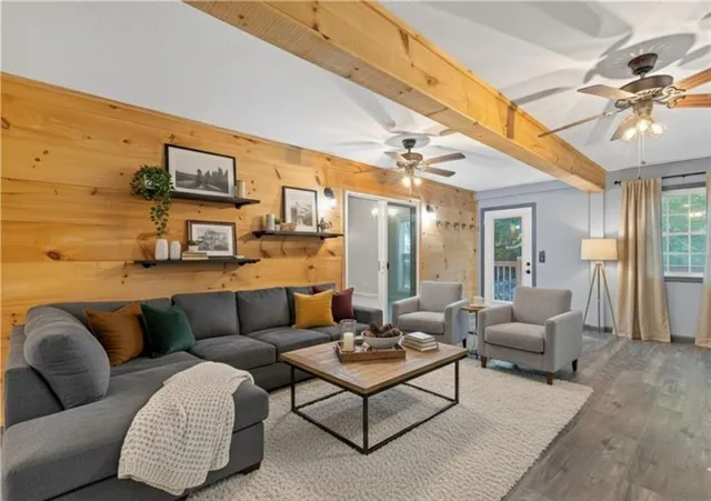 a living room with furniture a rug and a flat screen tv