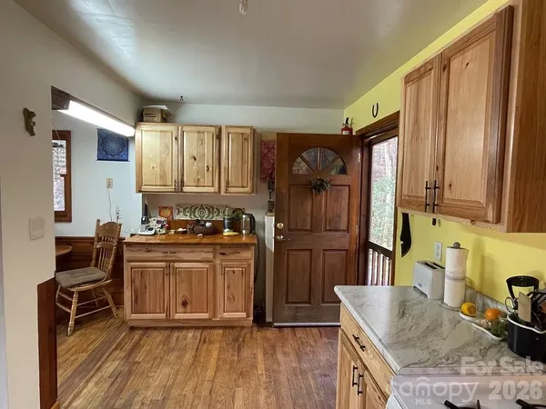 a kitchen with granite countertop a sink stove and refrigerator