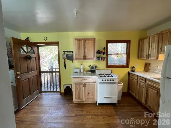 a kitchen with stainless steel appliances granite countertop a stove a sink dishwasher and a refrigerator