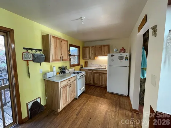 a utility room with wooden floor washer and dryer