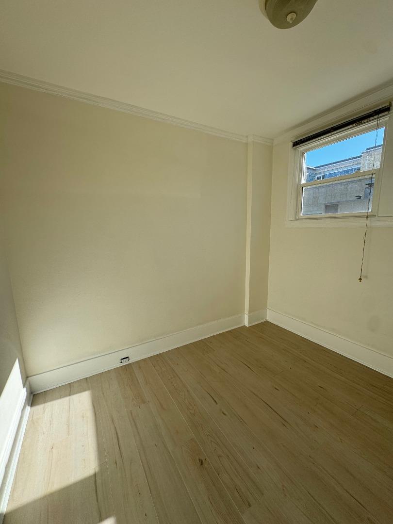 268 Lorton Avenue, Unit 2 Burlingame, CA 94010 - Photo 3 of 4 an empty room with wooden floor and windows