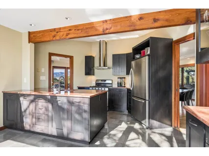a kitchen with stainless steel appliances granite countertop a refrigerator and a stove