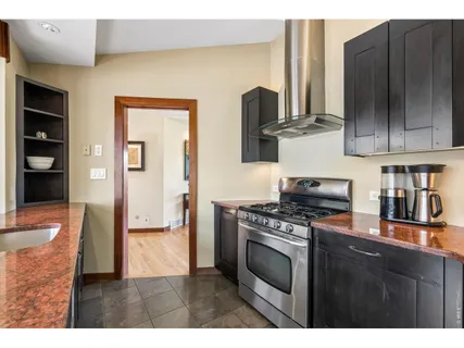 a kitchen with stainless steel appliances granite countertop a refrigerator stove and sink
