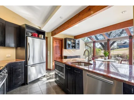 a kitchen with stainless steel appliances granite countertop a refrigerator and a sink